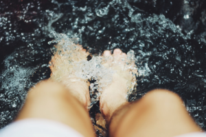 person soaking feet in water