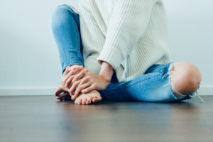 a person holding their feet