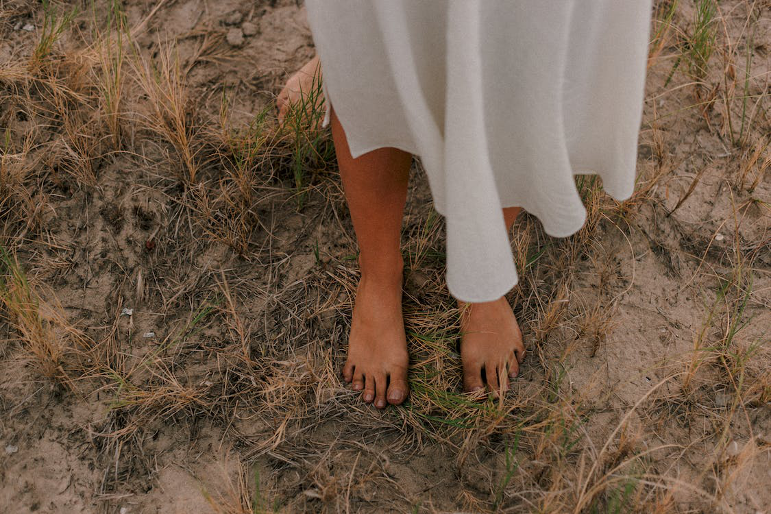 Bare Feet On Dry Grass