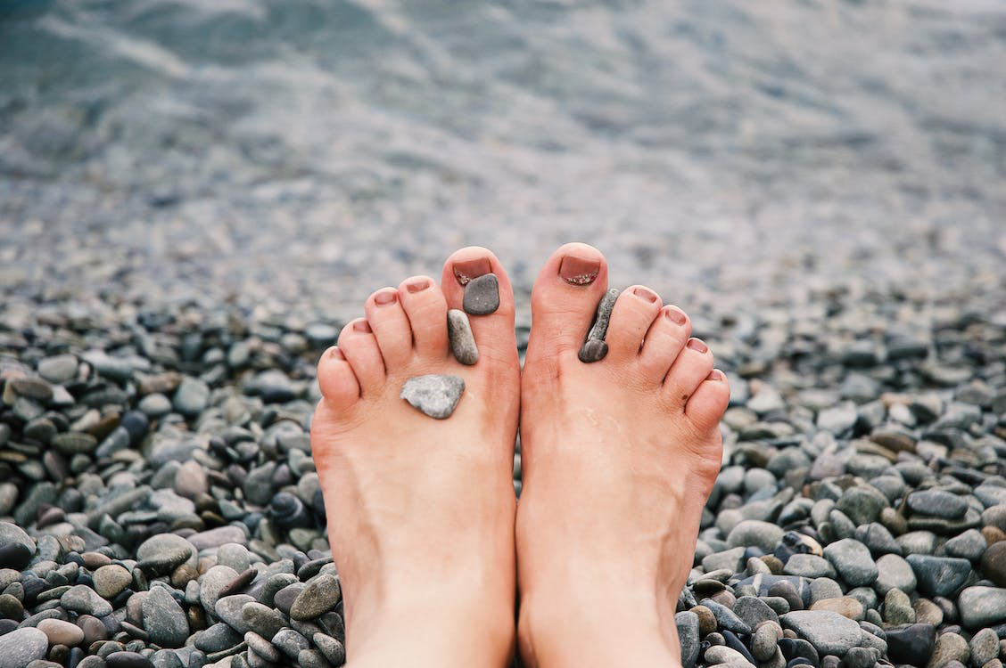 Feet With Balanced Pebbles