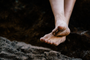 Bare feet dusted with sand.